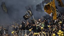 Aficionados de Los Angeles FC celebran durante el partido de fútbol entre Los Angeles FC y Club América en el BMO Stadium de Los Ángeles, California, EE. UU.EFE/EPA/ALLISON DINNER